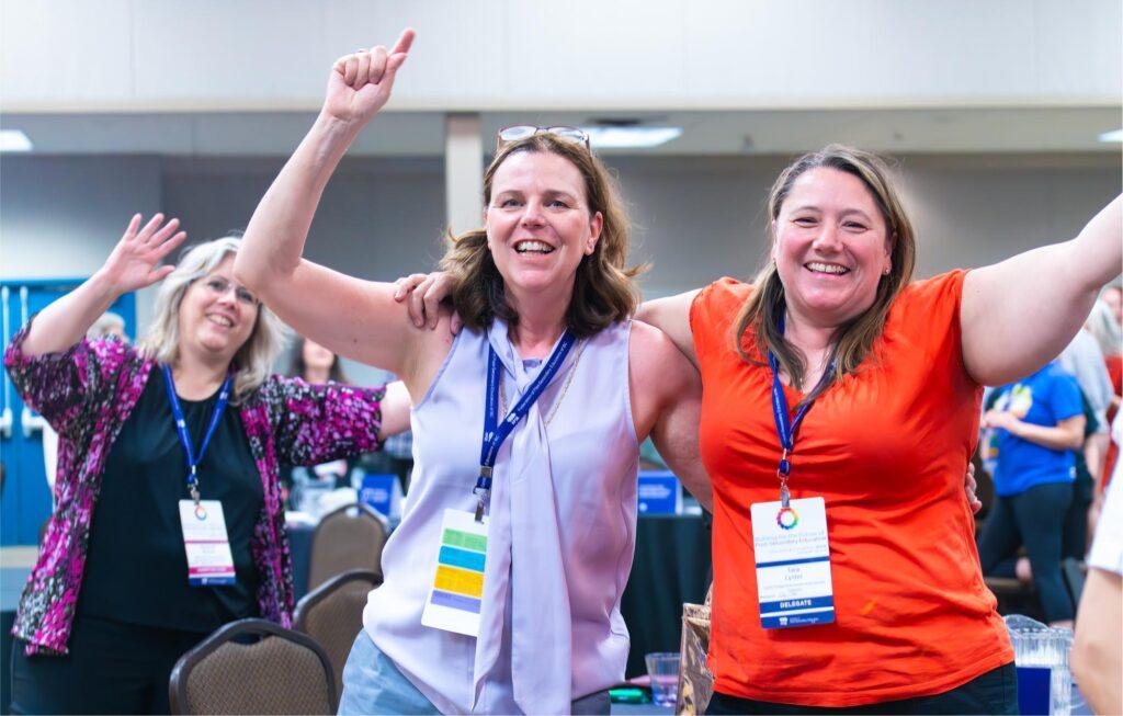 Members with hands raised, looking happy